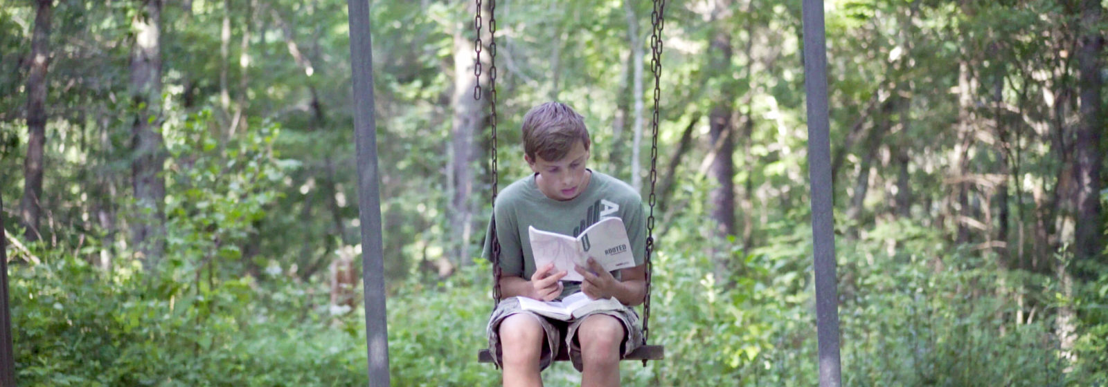 student holding a mission trip devotional